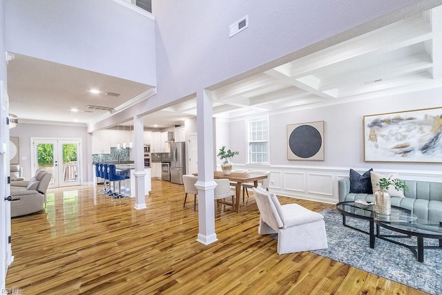 1161 Bells Mill Rd, Chesapeake, VA 23322 - living area featuring crown molding, light wood-style floors, beam ceiling, coffered ceiling, and french doors