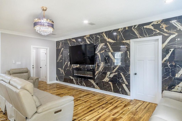 1161 Bells Mill Rd, Chesapeake, VA 23322 - living room featuring crown molding, an accent wall, wood finished floors, a chandelier, and tile walls