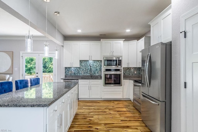 1161 Bells Mill Rd, Chesapeake, VA 23322 - kitchen with appliances with stainless steel finishes, light wood-style flooring, decorative backsplash, white cabinetry, and dark stone countertops