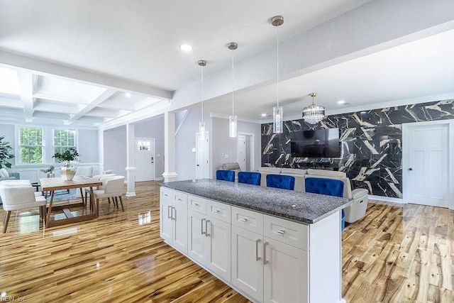 1161 Bells Mill Rd, Chesapeake, VA 23322 - kitchen with open floor plan, light wood-style flooring, beam ceiling, a center island, and dark stone counters