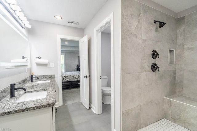 1161 Bells Mill Rd, Chesapeake, VA 23322 - ensuite bathroom featuring double vanity, a tile shower, and recessed lighting