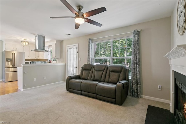 102 Saddle Dr, Newport News, VA 23602 - living area featuring ceiling fan, a fireplace with flush hearth, and light colored carpet