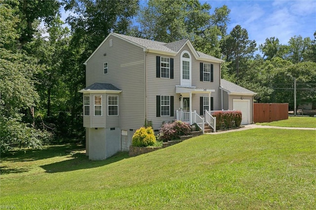 102 Saddle Dr, Newport News, VA 23602 - colonial-style house featuring a garage, driveway, a front lawn, and view of wooded area