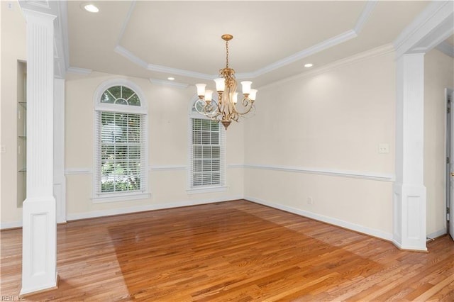 1938 Lancing Crest Ln, Chesapeake, VA 23323 - empty room with ornate columns, a tray ceiling, wood finished floors, a chandelier, and crown molding