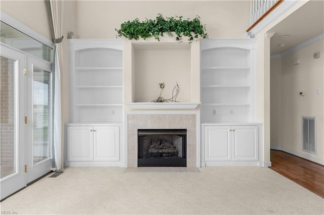 1938 Lancing Crest Ln, Chesapeake, VA 23323 - unfurnished living room featuring ornamental molding, a tile fireplace, and built in shelves