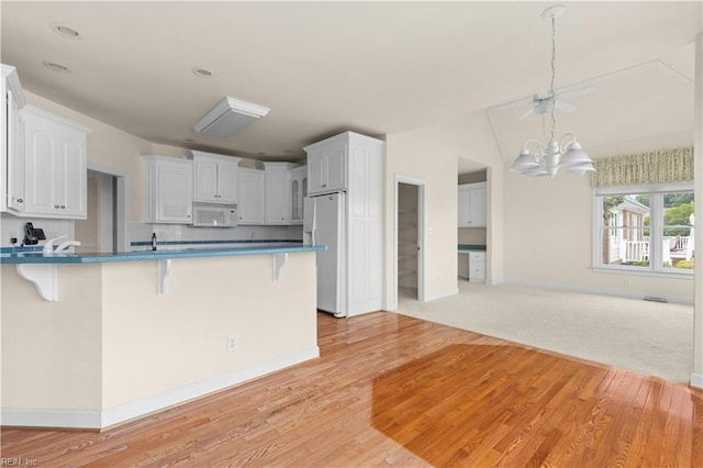 1938 Lancing Crest Ln, Chesapeake, VA 23323 - kitchen featuring white appliances, a kitchen bar, a chandelier, and open floor plan