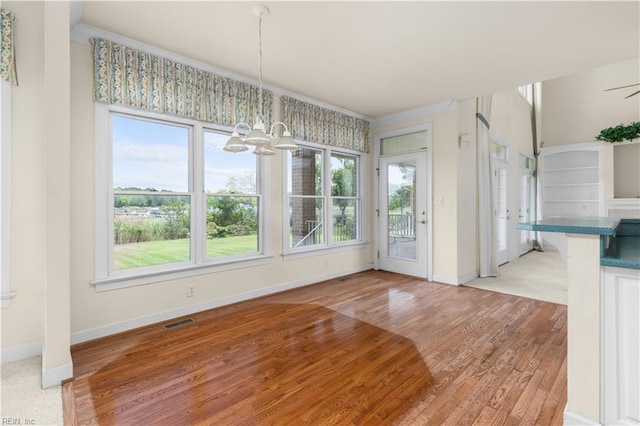 1938 Lancing Crest Ln, Chesapeake, VA 23323 - unfurnished dining area featuring a chandelier, healthy amount of natural light, light wood-type flooring, and crown molding