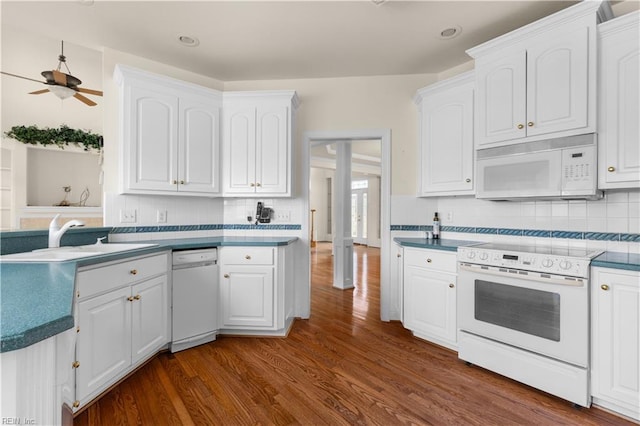1938 Lancing Crest Ln, Chesapeake, VA 23323 - kitchen with white appliances, dark wood finished floors, white cabinets, backsplash, and recessed lighting