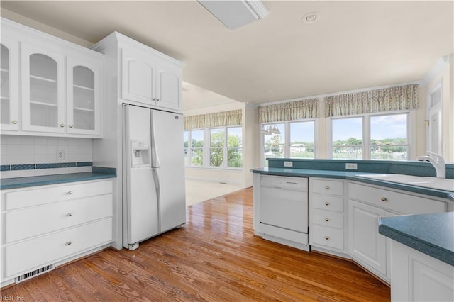 1938 Lancing Crest Ln, Chesapeake, VA 23323 - kitchen with white appliances, wood finished floors, white cabinets, glass insert cabinets, and dark countertops