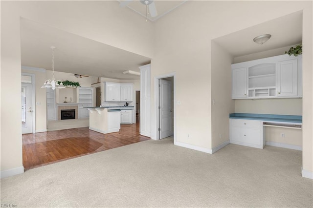 1938 Lancing Crest Ln, Chesapeake, VA 23323 - kitchen featuring light carpet, open floor plan, a ceiling fan, white cabinets, and open shelves