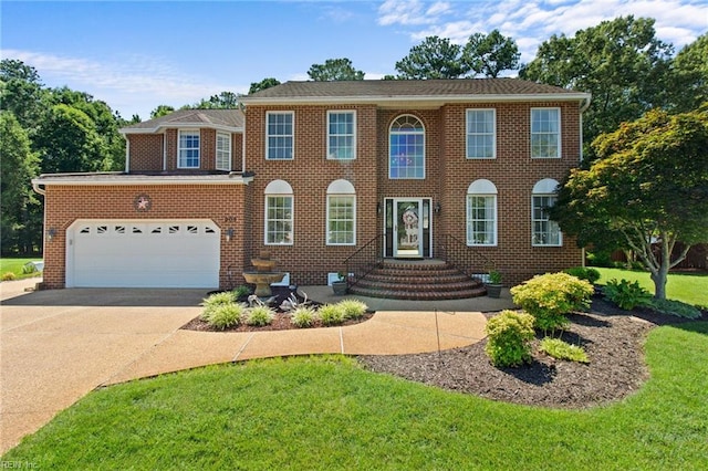 203 Vixen Ct, Yorktown, VA 23693 - view of front of property with driveway, a front lawn, brick siding, and a garage