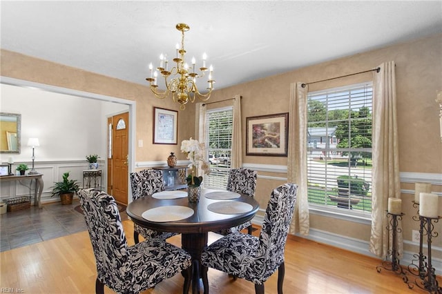203 Vixen Ct, Yorktown, VA 23693 - dining area featuring a chandelier, wood finished floors, and a wainscoted wall