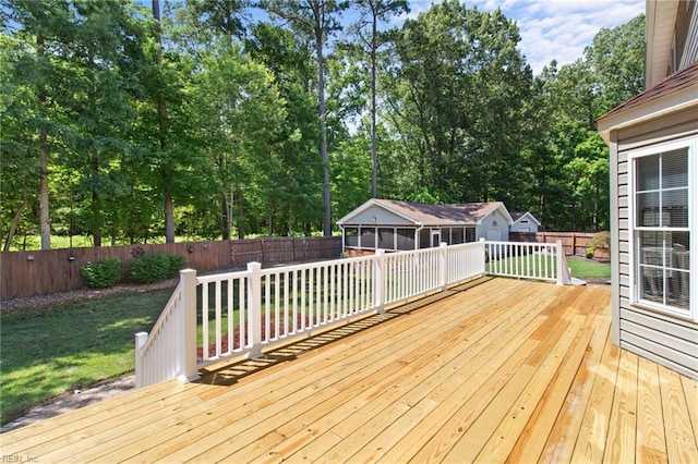 203 Vixen Ct, Yorktown, VA 23693 - deck with a fenced backyard, view of wooded area, an outbuilding, and a sunroom