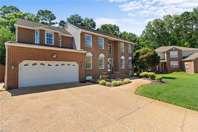 203 Vixen Ct, Yorktown, VA 23693 - view of front facade with driveway, a garage, brick siding, and a front yard