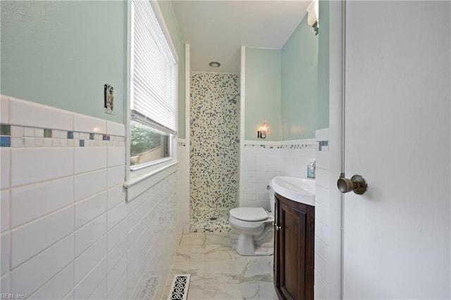 205 Ridgeland Dr, Smithfield, VA 23430 - bathroom featuring tile walls, a stall shower, vanity, wainscoting, and marble finish floors