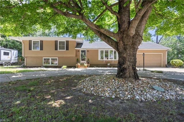 205 Ridgeland Dr, Smithfield, VA 23430 - split level home with concrete driveway, a garage, and entry steps