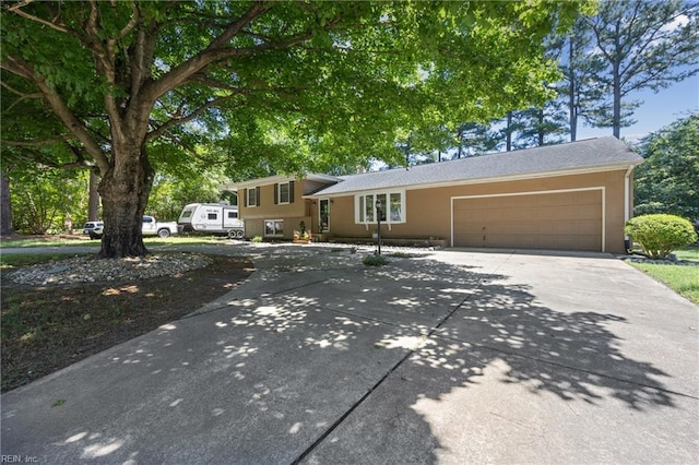 205 Ridgeland Dr, Smithfield, VA 23430 - split level home featuring concrete driveway and an attached garage