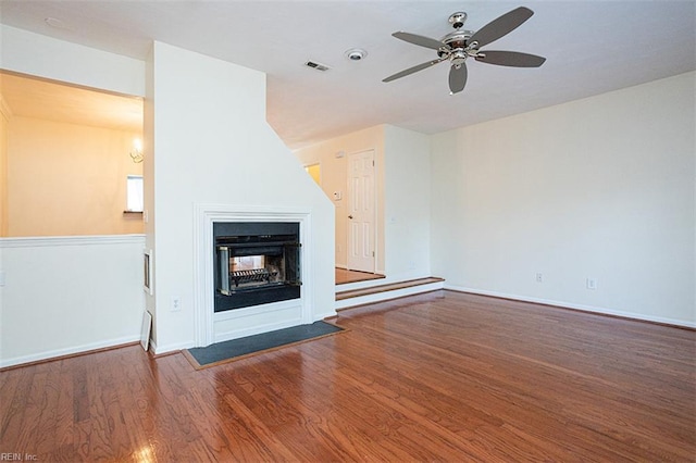 751 S Lake Cir, Chesapeake, VA 23322 - unfurnished living room with wood finished floors, a ceiling fan, and a multi sided fireplace