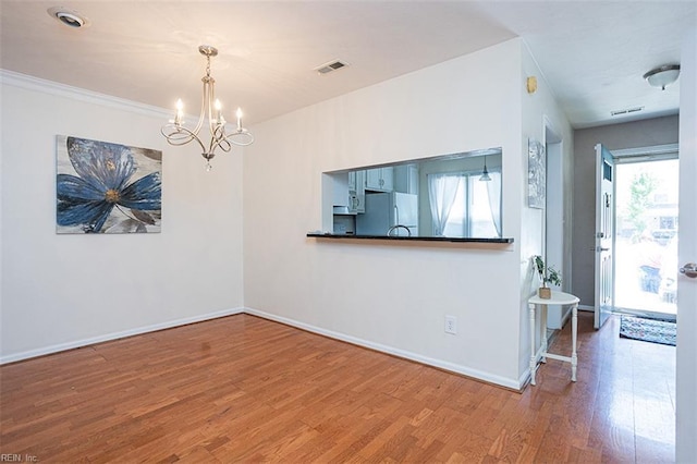 751 S Lake Cir, Chesapeake, VA 23322 - unfurnished dining area with a chandelier and wood finished floors