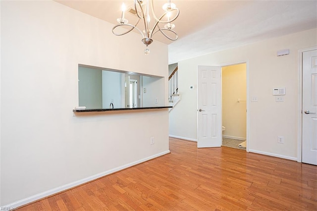 751 S Lake Cir, Chesapeake, VA 23322 - unfurnished living room with a chandelier and wood finished floors