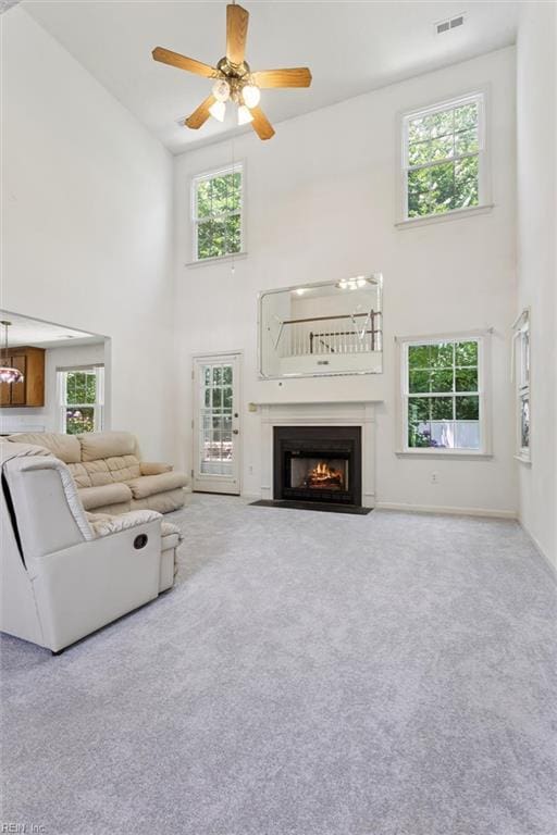 104 Hounds Chase Chase, Yorktown, VA 23693 - carpeted living area with a high ceiling, healthy amount of natural light, a fireplace with flush hearth, and ceiling fan
