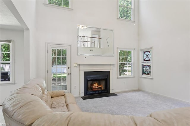 104 Hounds Chase Chase, Yorktown, VA 23693 - carpeted living room with a towering ceiling and a fireplace with flush hearth