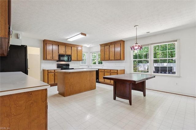 104 Hounds Chase Chase, Yorktown, VA 23693 - kitchen featuring black appliances, brown cabinetry, light countertops, a textured ceiling, and hanging light fixtures