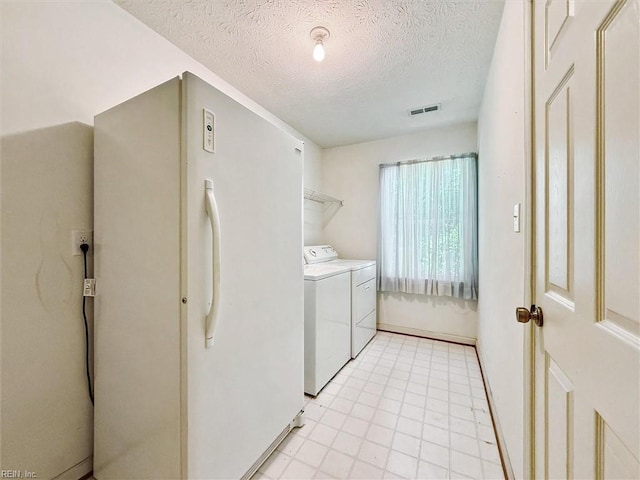 104 Hounds Chase Chase, Yorktown, VA 23693 - laundry area featuring washing machine and clothes dryer and a textured ceiling