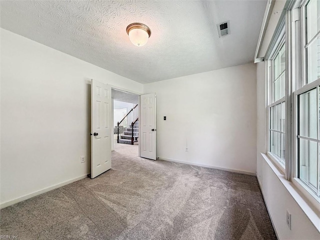 104 Hounds Chase Chase, Yorktown, VA 23693 - carpeted spare room featuring plenty of natural light, stairs, and a textured ceiling