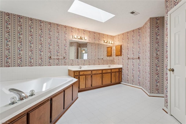 104 Hounds Chase Chase, Yorktown, VA 23693 - full bath featuring wallpapered walls, a skylight, double vanity, and a garden tub