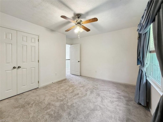104 Hounds Chase Chase, Yorktown, VA 23693 - unfurnished bedroom with carpet floors, a closet, a textured ceiling, and a ceiling fan