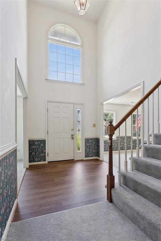 104 Hounds Chase Chase, Yorktown, VA 23693 - entrance foyer with stairs, a towering ceiling, wood finished floors, plenty of natural light, and wallpapered walls