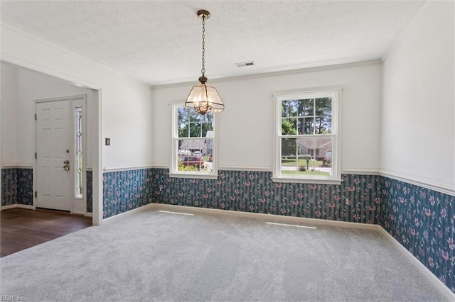 104 Hounds Chase Chase, Yorktown, VA 23693 - unfurnished dining area with wallpapered walls, carpet flooring, healthy amount of natural light, wainscoting, and crown molding