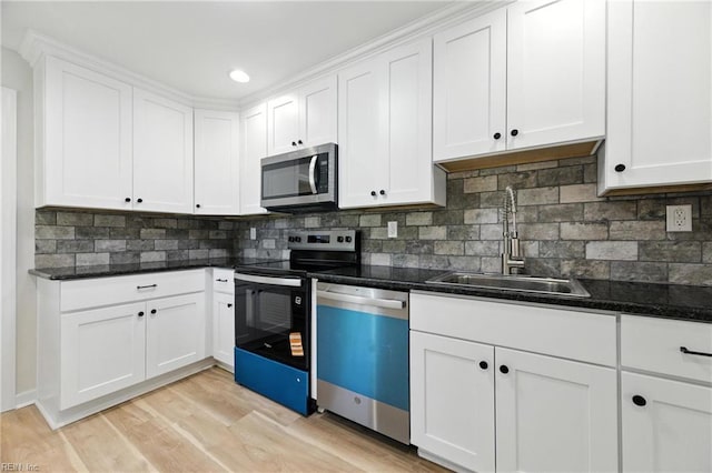 704 73rd St, Newport News, VA 23605 - kitchen with stainless steel appliances, white cabinets, tasteful backsplash, light wood-type flooring, and recessed lighting