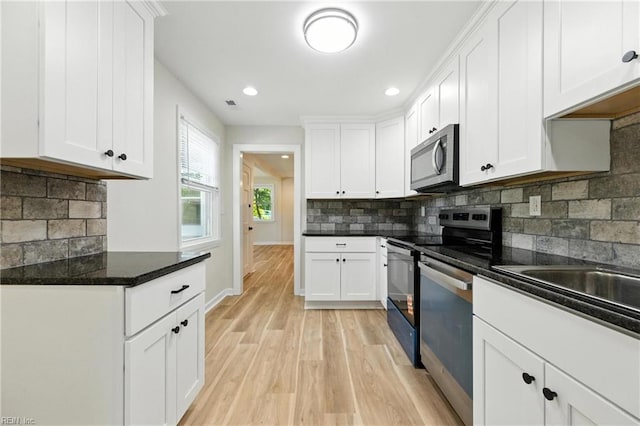 704 73rd St, Newport News, VA 23605 - kitchen featuring stainless steel appliances, light wood finished floors, backsplash, white cabinetry, and recessed lighting