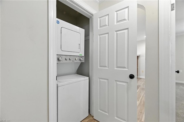 704 73rd St, Newport News, VA 23605 - laundry room with stacked washer / drying machine, arched walkways, and light wood-type flooring