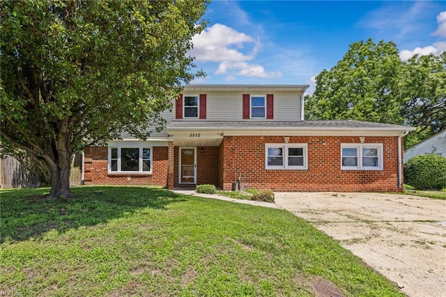 3012 Camelot Blvd, Chesapeake, VA 23323 - traditional-style house with a front lawn, driveway, and brick siding