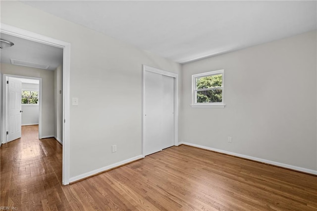 3012 Camelot Blvd, Chesapeake, VA 23323 - unfurnished bedroom with wood finished floors, multiple windows, and a closet