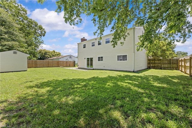 3012 Camelot Blvd, Chesapeake, VA 23323 - rear view of property featuring a fenced backyard, a chimney, and a storage unit