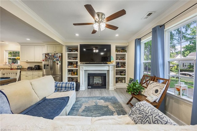 404 E Lorengo Ave, Norfolk, VA 23503 - living area featuring a glass covered fireplace, a ceiling fan, light wood finished floors, crown molding, and recessed lighting