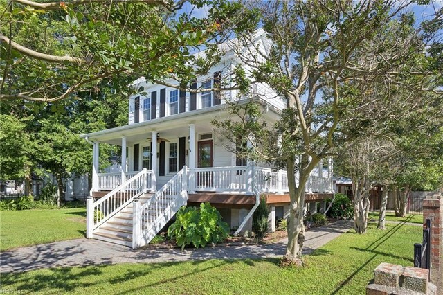 515 Beach Rd, Hampton, VA 23664 - view of front of home with covered porch, a front lawn, a ceiling fan, and stairs