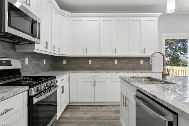 461 Joy Dr, Hampton, VA 23666 - kitchen with appliances with stainless steel finishes, white cabinetry, light wood finished floors, and light stone countertops