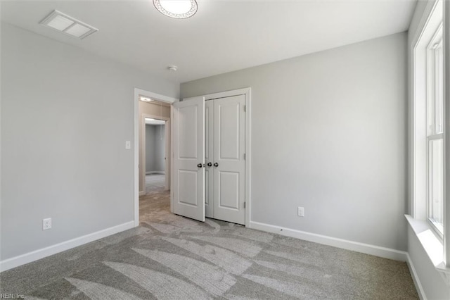 461 Joy Dr, Hampton, VA 23666 - unfurnished bedroom with multiple windows, light carpet, and a closet