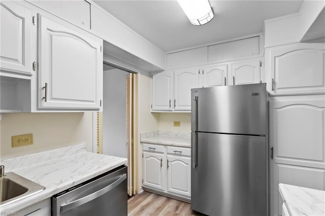 7320 Glenroie Ave Unit 5G, Norfolk, VA 23505 - kitchen featuring stainless steel appliances, white cabinets, light wood-type flooring, and light stone counters