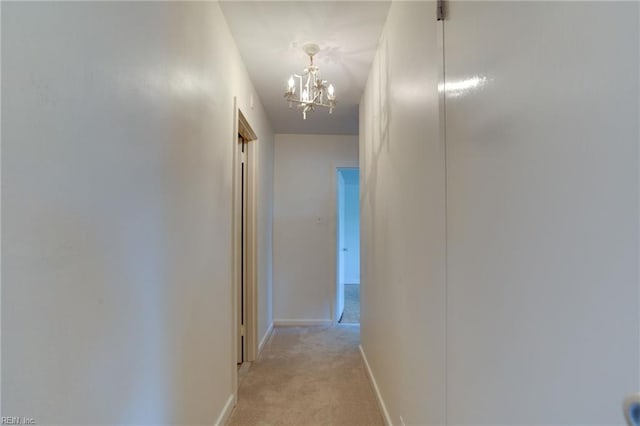 7320 Glenroie Ave Unit 5G, Norfolk, VA 23505 - hallway featuring a chandelier and light carpet