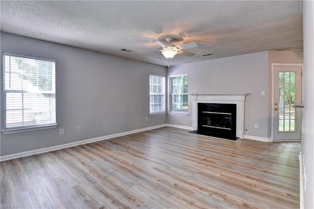 3957 Driftwood Way, Williamsburg, VA 23188 - unfurnished living room with a textured ceiling, a ceiling fan, wood finished floors, and a fireplace with flush hearth