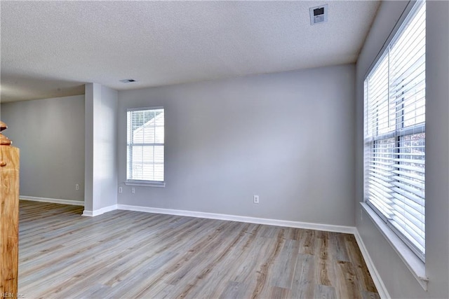 3957 Driftwood Way, Williamsburg, VA 23188 - spare room featuring a textured ceiling and wood finished floors