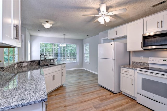 3957 Driftwood Way, Williamsburg, VA 23188 - kitchen with white appliances, white cabinetry, light wood-style flooring, a peninsula, and a textured ceiling