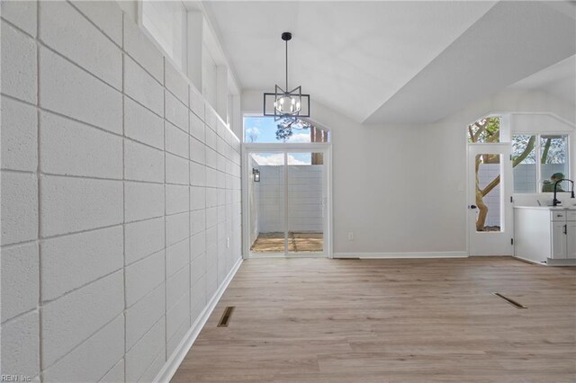 1320 Clay St, Franklin, VA 23851 - unfurnished dining area with light wood finished floors, plenty of natural light, vaulted ceiling, and a chandelier