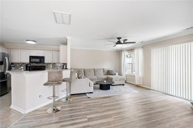 200 Burgundy Rd, Williamsburg, VA 23185 - living area featuring light wood-type flooring, a ceiling fan, and ornamental molding